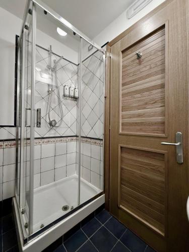 a shower with a glass door in a bathroom at Le Mandrelle Beach Resort in Amantea