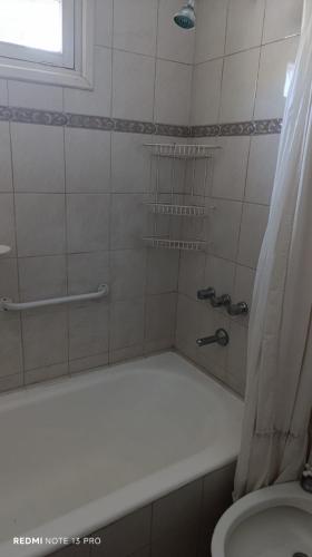 a bathroom with a tub and a toilet and a shower at la morada in General Alvear