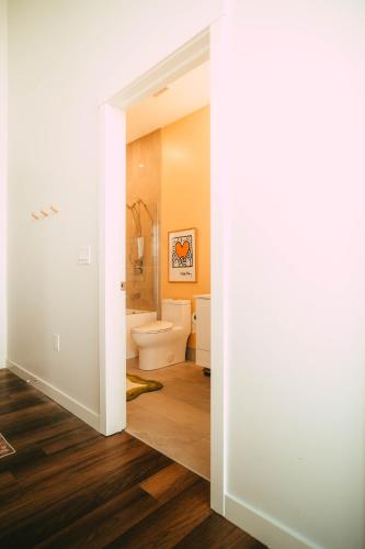 a bathroom with a toilet and a sink at Penthouse - Luxe Stay with Views - Free Parking in Halifax