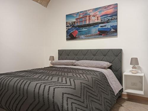 a bedroom with a bed and a picture on the wall at Bari Sweet Home 45 in Bari