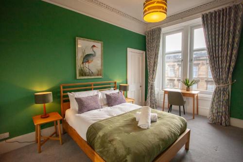 a green bedroom with a bed and a window at Newly Renovated Flat in Trendy Finnieston in Glasgow