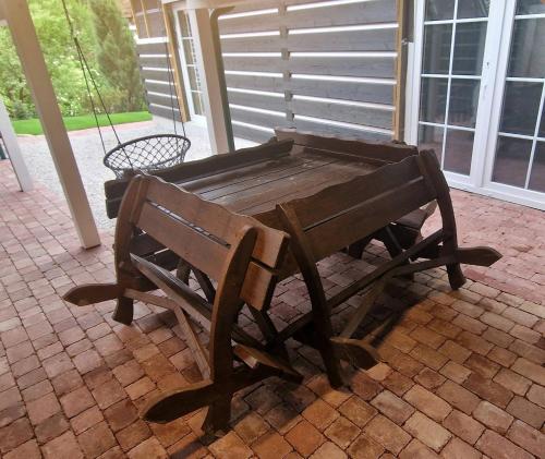 a wooden bench sitting on top of a patio at Drevenica Remata in Ráztočno