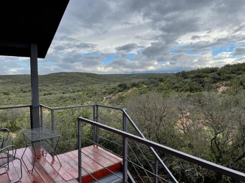 a balcony of a house with a view at Klein Karoo Game Lodge in Oudtshoorn