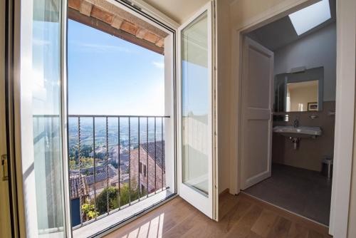 a bathroom with a large window and a sink at Hotel Il Palazzo in Assisi
