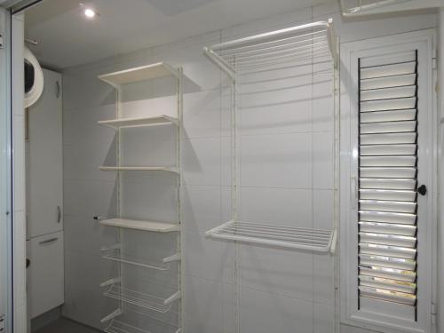a walk in closet with white shelves and a door at GRAN BILBAO I in Barakaldo
