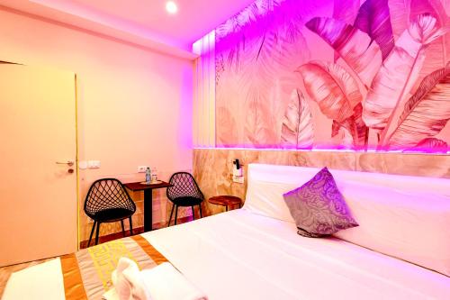 a bedroom with a bed with purple lighting at Bed Cinecittadue in Rome
