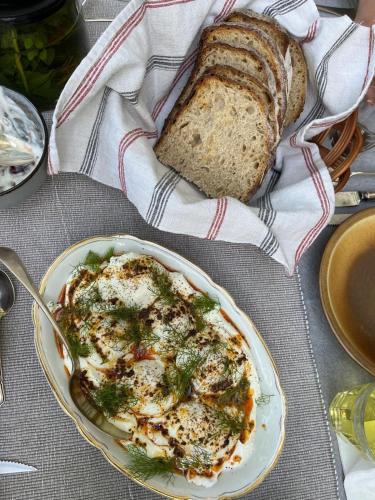 a plate of food on a table with a plate of bread at Bolara 60: the Guesthouse in Grožnjan