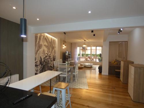 a dining room and living room with a table and chairs at GRAN BILBAO I in Barakaldo