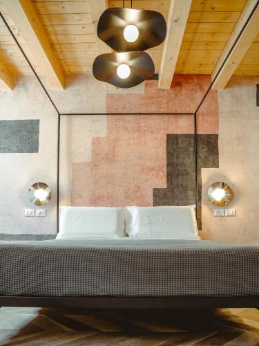 a bedroom with a bed and a ceiling fan at BRE Apartments - Aedes in Vicenza