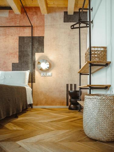 a bedroom with a bed and a clock on the wall at BRE Apartments - Aedes in Vicenza