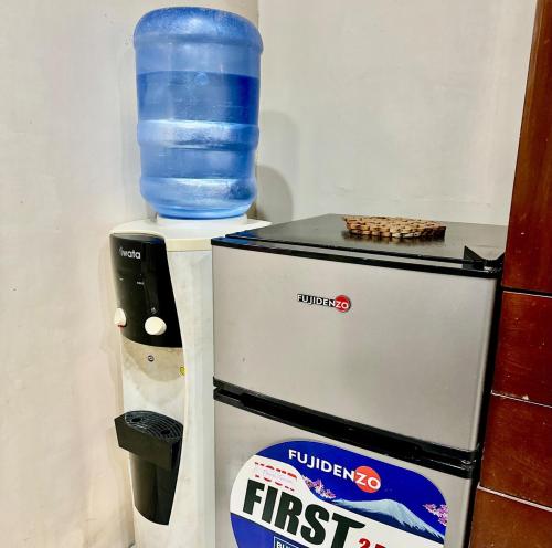 a bottle of water sitting on top of a refrigerator at Entire House at Club Morocco Beach Club Subic in Subic