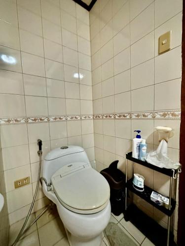 a bathroom with a toilet with a hose at Entire House at Club Morocco Beach Club Subic in Subic