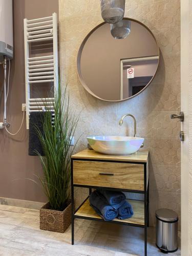 a bathroom with a sink and a mirror at Paris - Szeged City Center in Szeged