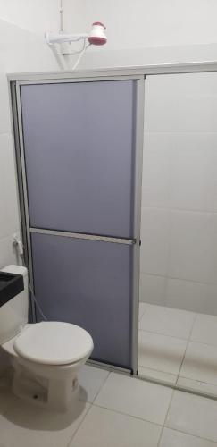 a bathroom with a white toilet and a counter at FAZENDA BOSQUE DAs PALMEIRAS in Itamaracá