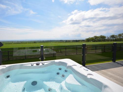 a jacuzzi tub on a deck with a view at 2 Bed in St Andrews 72436 in Anstruther