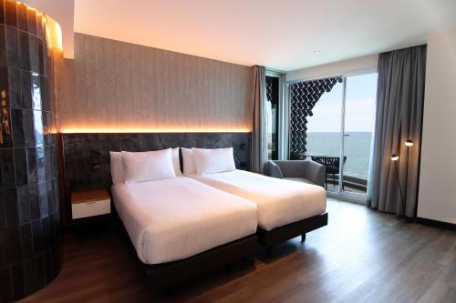 a hotel room with a bed and a balcony at Silken Saaj Maar - Adults Only in Puerto de la Cruz
