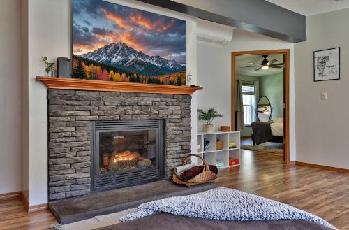 a living room with a fireplace with a mountain painting on the wall at Blueberry Hill Escape Pet Friendly HotTub Fire pit in Bridgewater