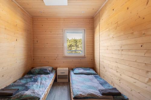 a small room with two beds and a window at Sielsko-Anielsko Kobyla Góra VI in Ligota