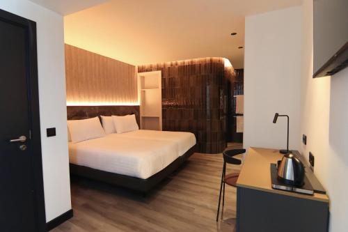 a hotel room with a bed and a desk at Silken Saaj Maar - Adults Only in Puerto de la Cruz