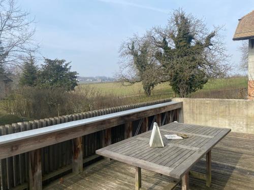 a wooden table with a napkin on a wooden deck at La Petite Campagne in Lonay