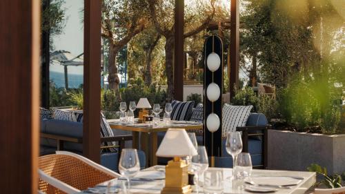 a restaurant with tables and chairs and trees at Jumeirah Marsa Al Arab Dubai in Dubai