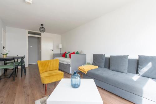 a living room with a couch and a table at Lovely 2-bed 20 mins to central London in London