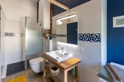 a bathroom with a sink and a toilet at Les Oliviers - Le Chant des Tongs in Salazac