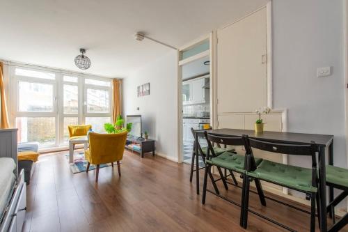 a living room with a dining room table and chairs at Lovely 2-bed 20 mins to central London in London