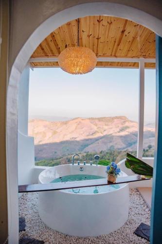 a bathroom with a tub with a view of the desert at Nontawa Villa Doichang in Ban Huai Khai