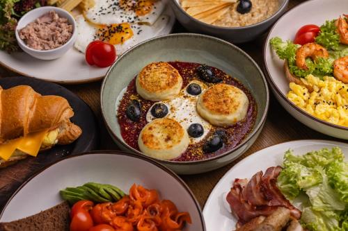a table topped with plates of breakfast foods at HIDE PARK Hotel in Vinnytsya