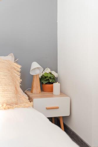 a bedroom with a bed and a nightstand with a lamp at Maison Piscine Chauffée Privée a 200 mn de la Plage in Rayol-Canadel-sur-Mer