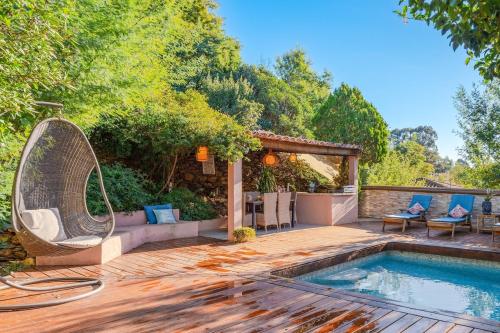 a backyard with a swimming pool and a wooden deck at Maison Piscine Chauffée Privée a 200 mn de la Plage in Rayol-Canadel-sur-Mer