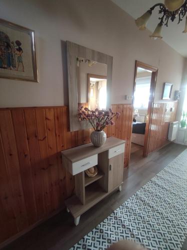 a room with a table with a vase of flowers on it at Villa Santamaría in Muxia