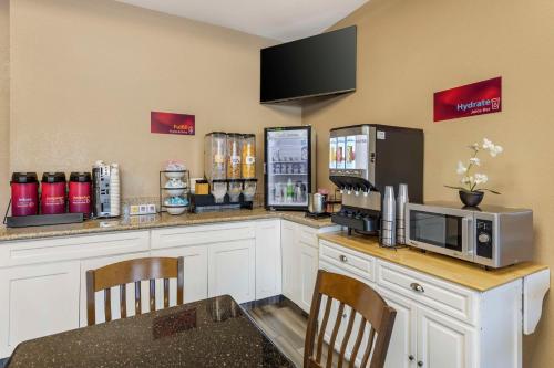 a kitchen with a counter with a microwave and a refrigerator at Best Western Plus Heritage Inn Ontario Rancho Cucamonga in Rancho Cucamonga