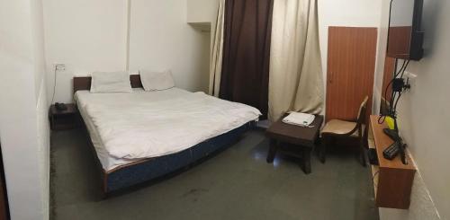 Postel nebo postele na pokoji v ubytování Hotel Krishna Guesthouse