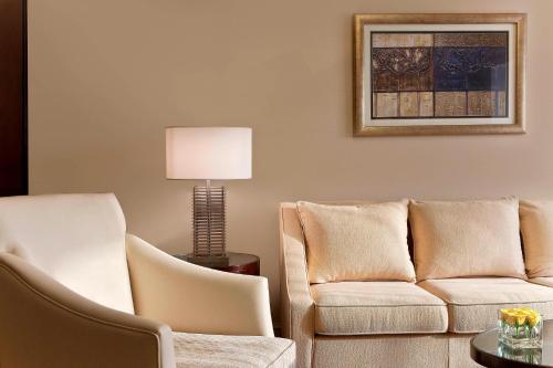 a living room with a couch and two chairs at Sheraton Xi'an Hotel in Xi'an
