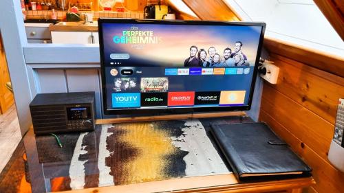 a tv sitting on top of a table at Landhaus Osborne near Hallstatt in Obertraun