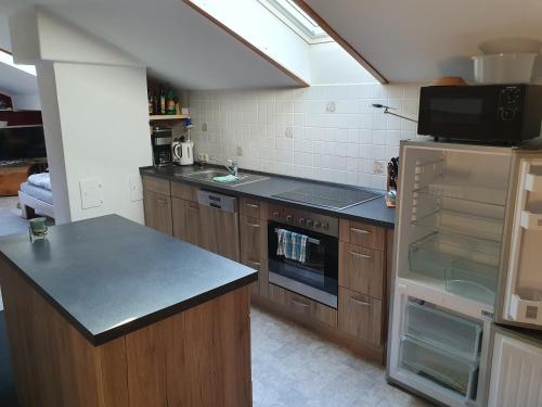 a kitchen with wooden cabinets and a counter top at Blick zum Riesenkopf in Brannenburg
