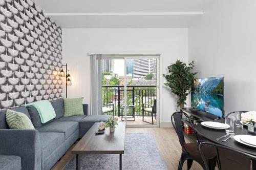 a living room with a couch and a table at The Tar Heel - Stylish 4BR with City Views - Free Parking - Gym in Charlotte