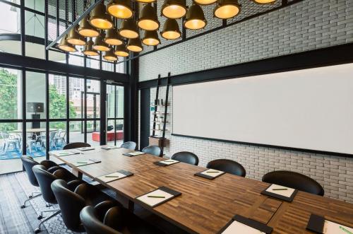 a conference room with a large wooden table and chairs at Holiday Inn Pattaya by IHG in Pattaya Central