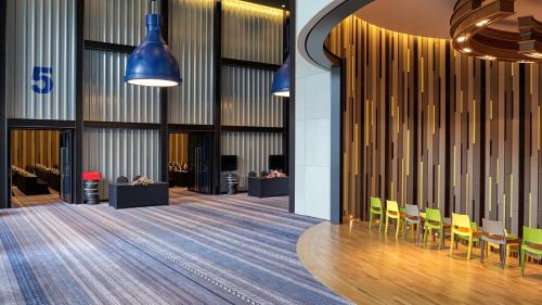 a view of the lobby of a building with yellow chairs at Holiday Inn Pattaya by IHG in Pattaya Central