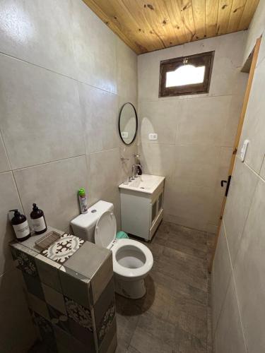 a small bathroom with a toilet and a sink at Cabanas Embau in San Rafael