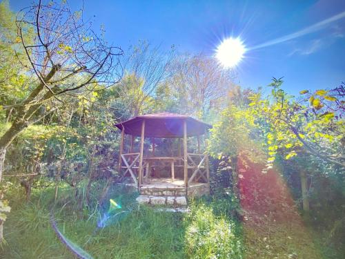 a gazebo in the middle of a garden at Hidden Gem Villa in Guri i Zi
