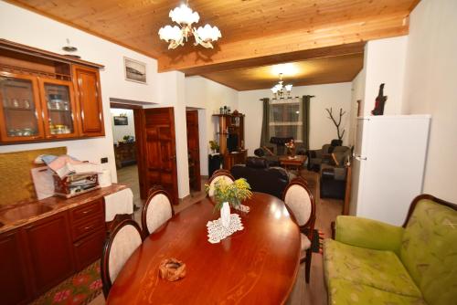 a dining room with a wooden table and chairs at Hidden Gem Villa in Guri i Zi