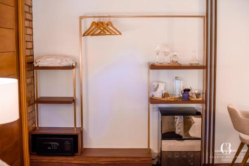 a room with a closet with shelves and a mirror at Casa Valduga Pousada Boutique in Bento Gonçalves