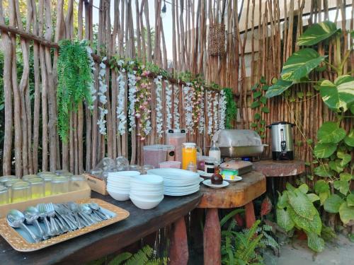 a table with plates and utensils on it at Arte Sano Hotel Only Adults - Near Beach in Holbox Island