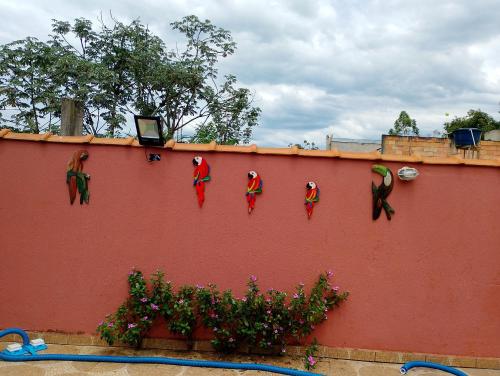 a wall with christmas decorations on top of it at Chácara paraíso in Tremembé