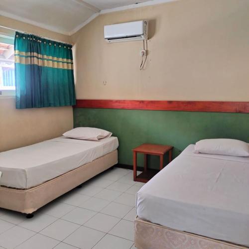 Postel nebo postele na pokoji v ubytování Villa Beach Anyer 1 by Anyer Adventure