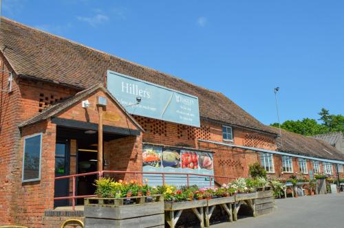 a brick building with flowers in front of it at Riverside House in Broom