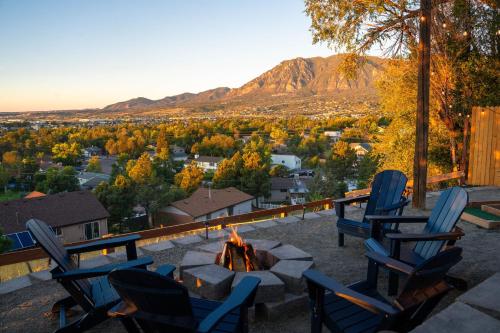 a group of chairs around a fire pit with a view at Mountain Views Climbing wall Mini Golf Hot tub in Colorado Springs